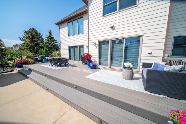 wooden terrace with outdoor dining space and outdoor lounge area