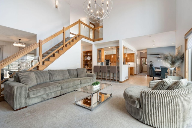 living area with light carpet, stairway, a high ceiling, and an inviting chandelier