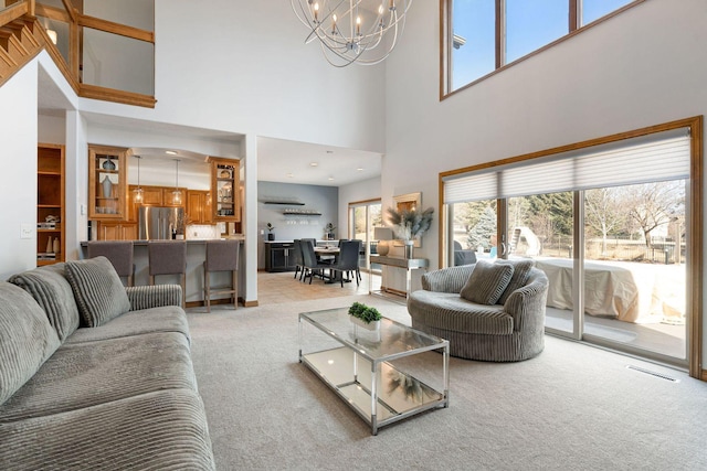 living area featuring light carpet, an inviting chandelier, and a wealth of natural light