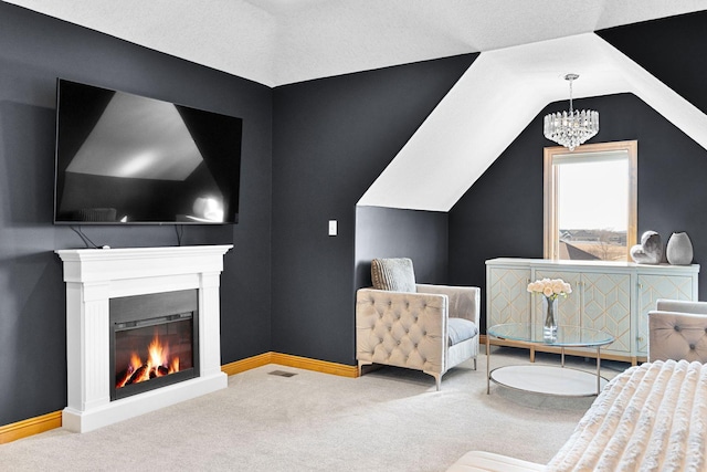 carpeted bedroom with visible vents, lofted ceiling, a warm lit fireplace, baseboards, and a chandelier