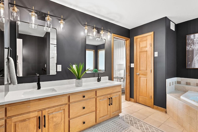 full bath featuring tile patterned flooring, visible vents, double vanity, a bath, and a sink