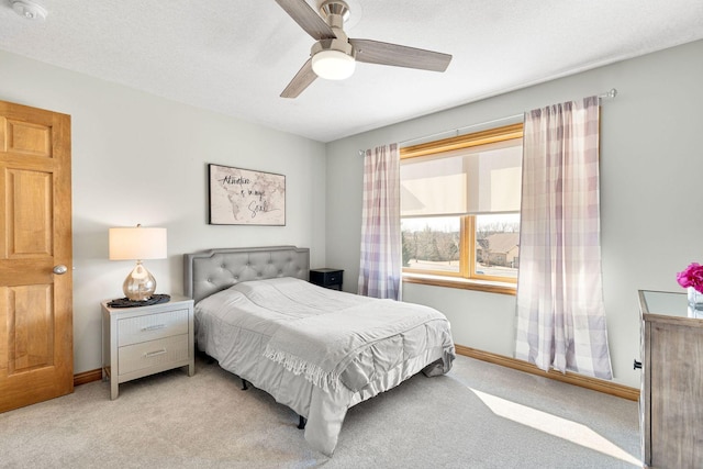 bedroom with carpet flooring, ceiling fan, a textured ceiling, and baseboards