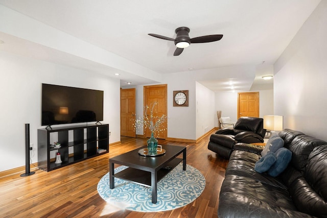 living room with a ceiling fan, wood finished floors, and baseboards