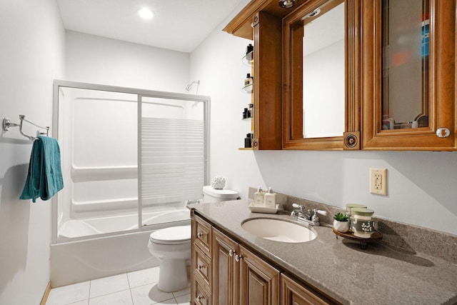 bathroom featuring tile patterned flooring, toilet, vanity, and combined bath / shower with glass door