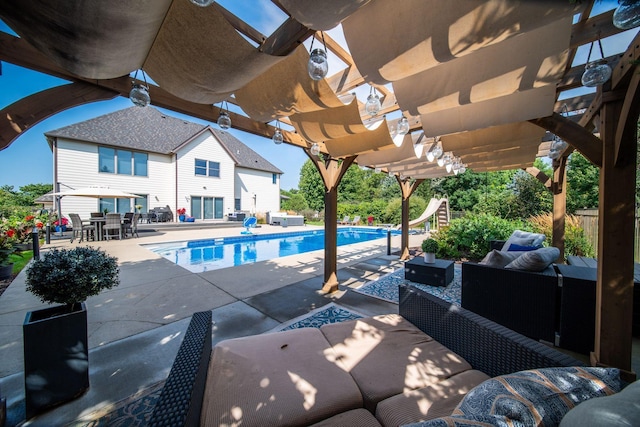 pool featuring a patio area, an outdoor living space, a pergola, and a water slide