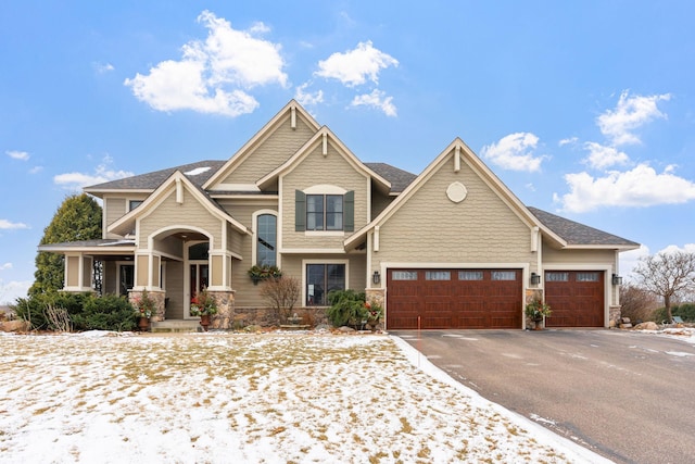 craftsman-style house featuring a porch and a garage