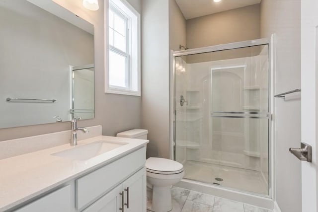 bathroom featuring an enclosed shower, vanity, and toilet