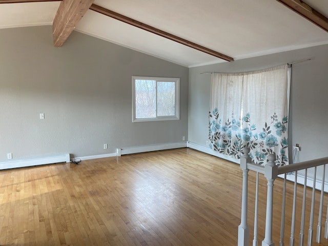 spare room featuring hardwood / wood-style floors, a baseboard radiator, and lofted ceiling with beams