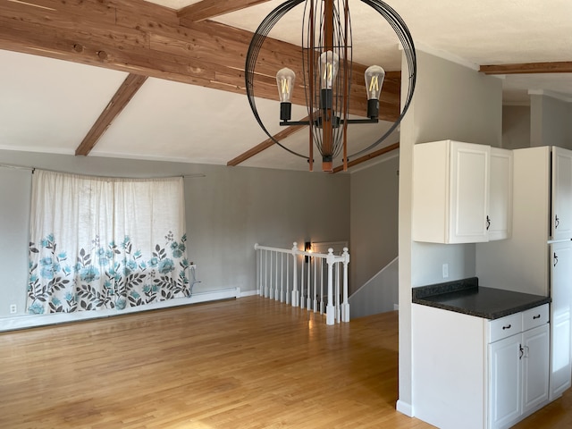 kitchen featuring vaulted ceiling with beams, an inviting chandelier, white cabinets, and light hardwood / wood-style floors