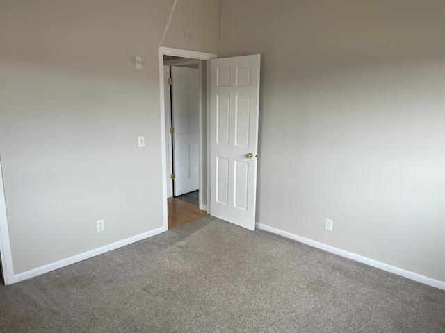 empty room with dark carpet