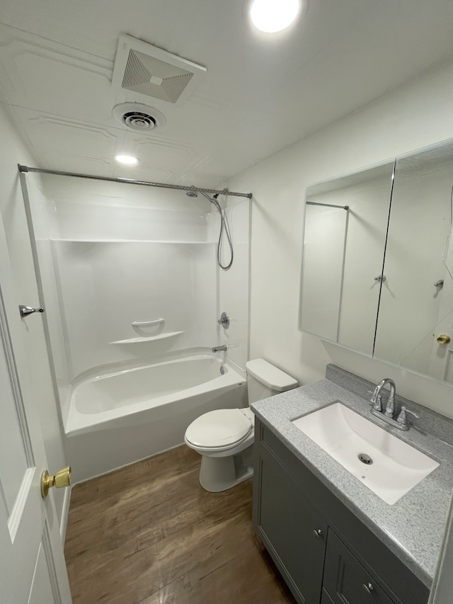 full bathroom featuring vanity, wood-type flooring, toilet, and shower / bath combination