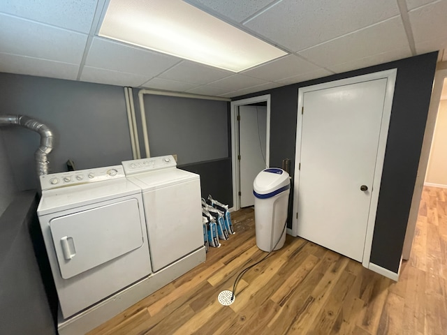 washroom with washing machine and dryer and light wood-type flooring