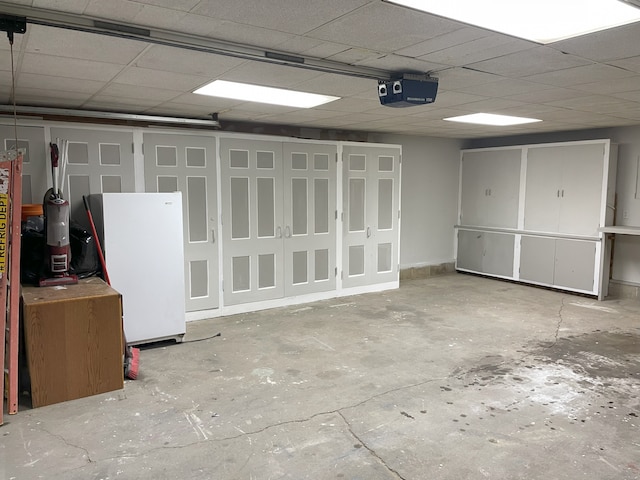 interior space featuring white refrigerator and a drop ceiling