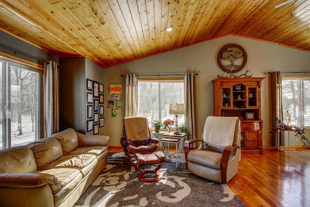 living area featuring baseboards, wood finished floors, vaulted ceiling, and wooden ceiling