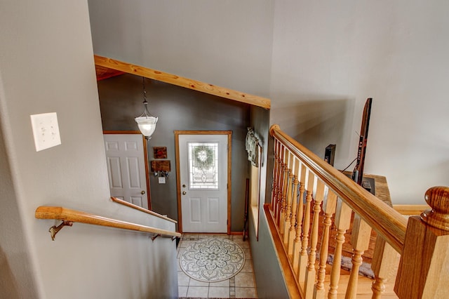 entryway with stairs and light tile patterned floors