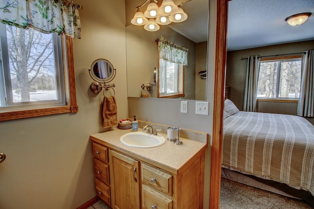 bathroom featuring an inviting chandelier and vanity