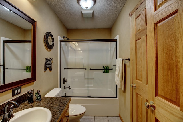 full bathroom with vanity, toilet, a textured ceiling, tile patterned floors, and bath / shower combo with glass door
