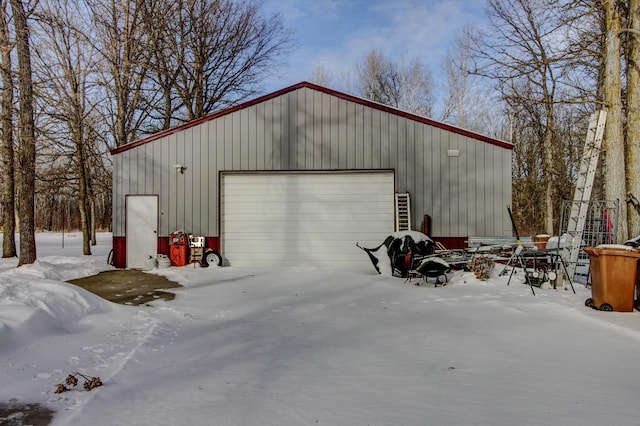 snow covered garage with a garage