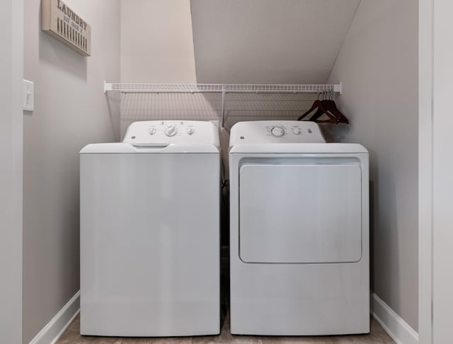 clothes washing area featuring separate washer and dryer