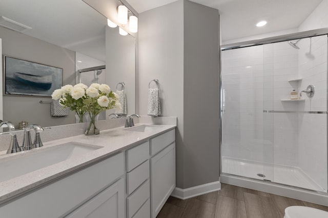 bathroom with vanity and a shower with shower door