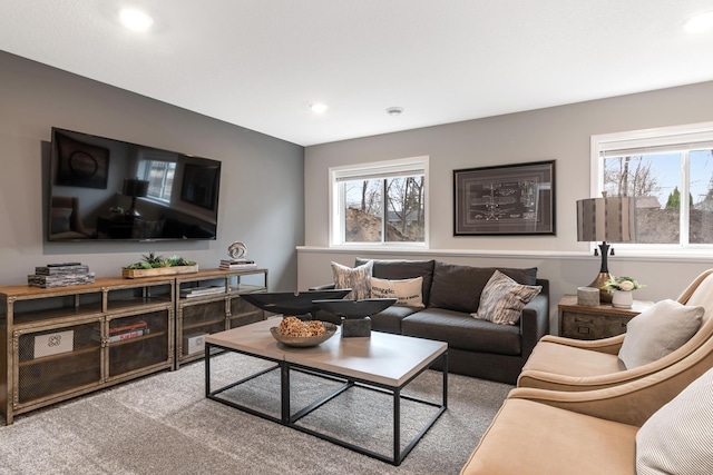 living room featuring carpet floors and a wealth of natural light