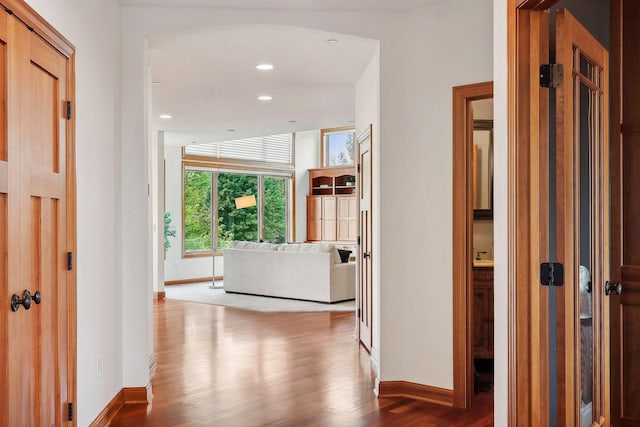 corridor with hardwood / wood-style floors