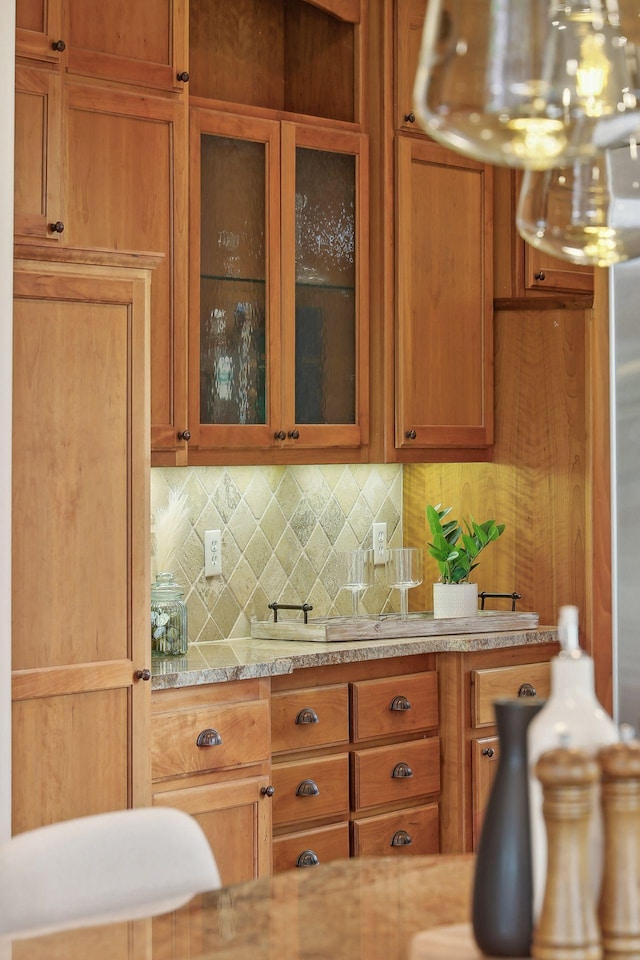 kitchen with light stone counters and decorative backsplash