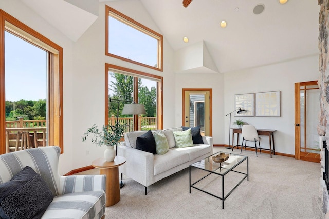 carpeted living room featuring a healthy amount of sunlight and high vaulted ceiling