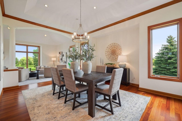 dining space featuring a notable chandelier, wood-type flooring, and ornamental molding