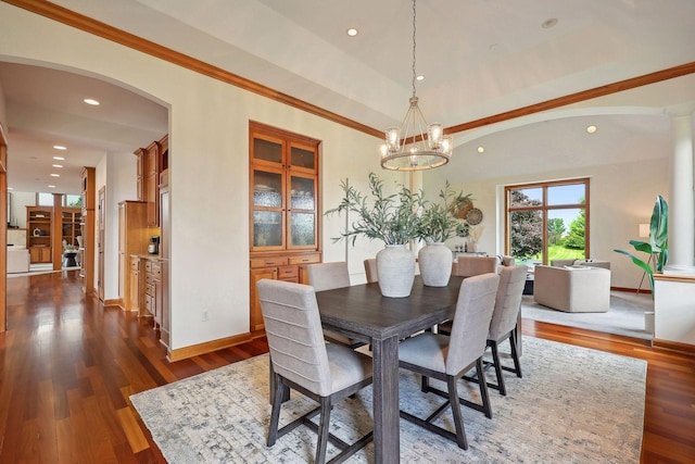 dining space featuring an inviting chandelier, crown molding, and dark hardwood / wood-style floors