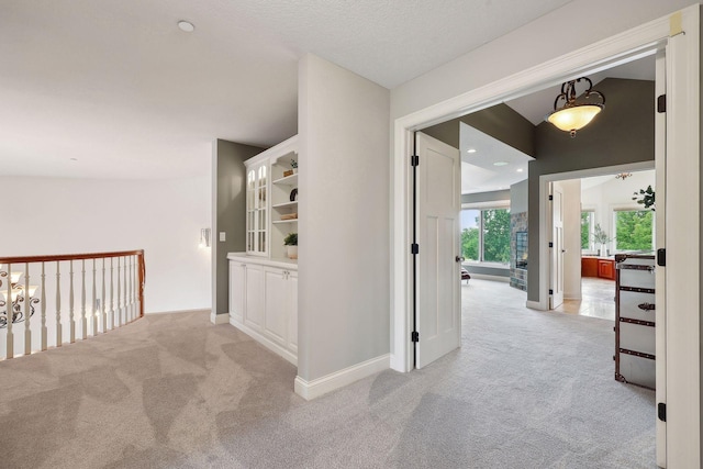 corridor with light colored carpet