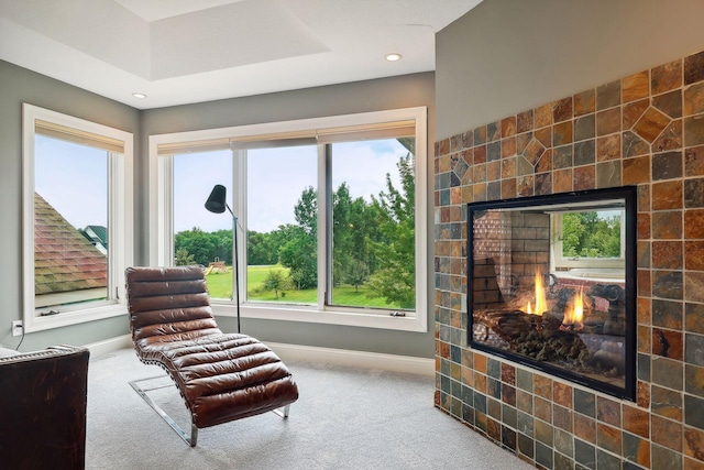 sitting room featuring carpet floors and a tile fireplace