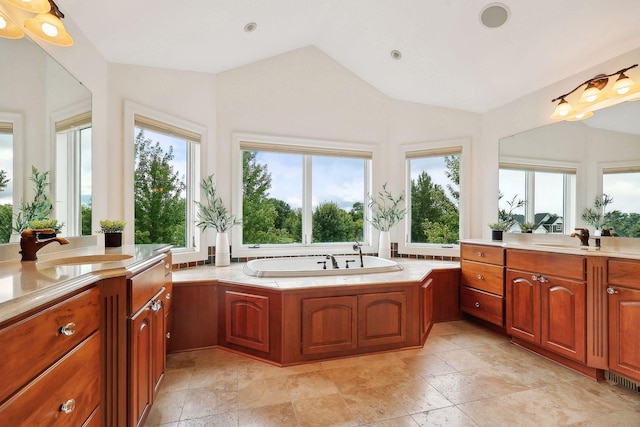 bathroom with lofted ceiling, a bath, and vanity