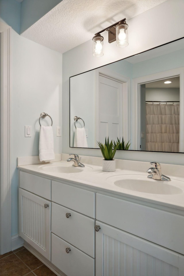 bathroom featuring vanity and a textured ceiling