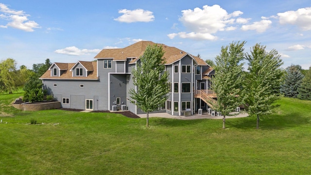 back of property with a wooden deck and a yard