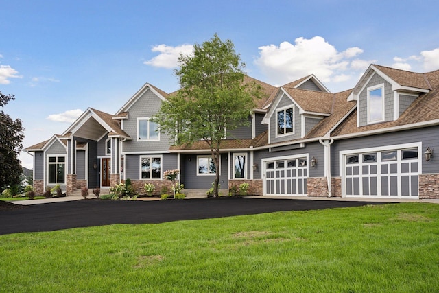 craftsman-style house featuring a garage and a front yard