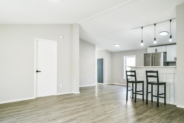 living room featuring lofted ceiling and wood-type flooring