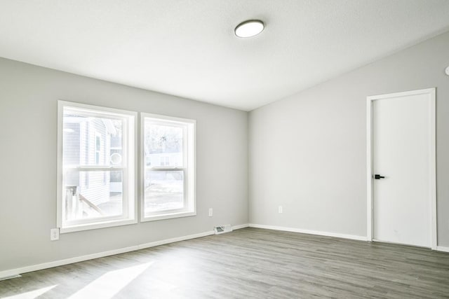 unfurnished room with dark hardwood / wood-style flooring