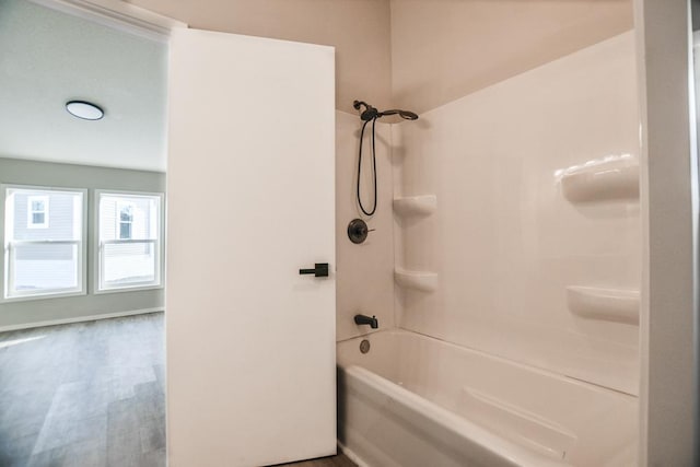 bathroom featuring hardwood / wood-style flooring and shower / bathtub combination