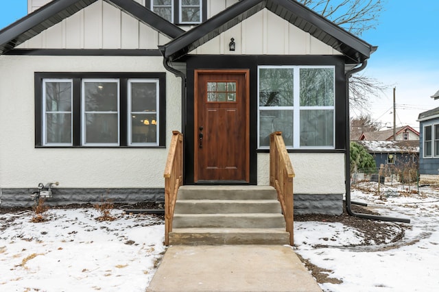 view of snow covered property entrance