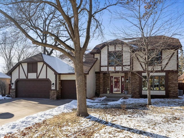 tudor house with a garage and cooling unit