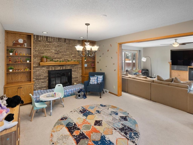 carpeted living room with built in features, ceiling fan with notable chandelier, a fireplace, and a textured ceiling