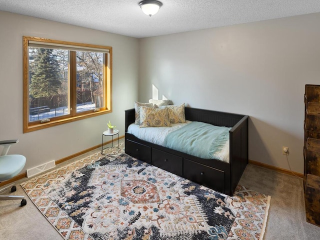 carpeted bedroom with a textured ceiling