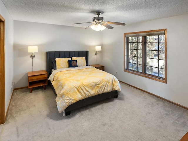 bedroom featuring ceiling fan, carpet, and a textured ceiling