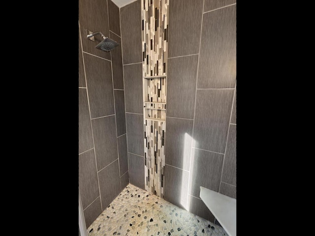 bathroom with a tile shower