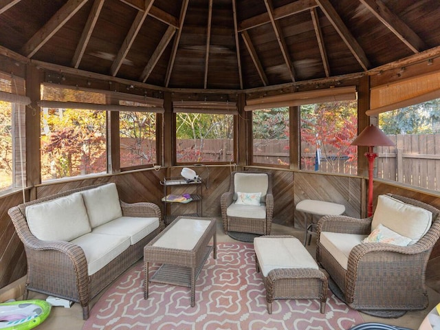 sunroom / solarium with lofted ceiling with beams and wood ceiling