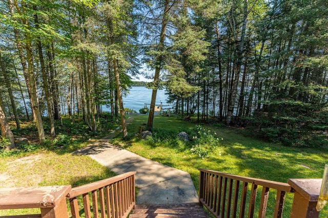 view of community with a yard and a water view