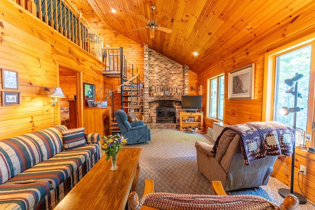 living room featuring a healthy amount of sunlight, wooden walls, and wooden ceiling