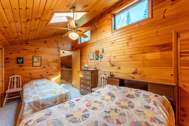 bedroom with wood ceiling, carpet floors, vaulted ceiling with skylight, and wood walls