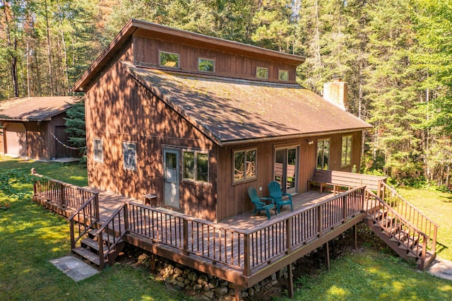 back of house featuring an outbuilding and a yard